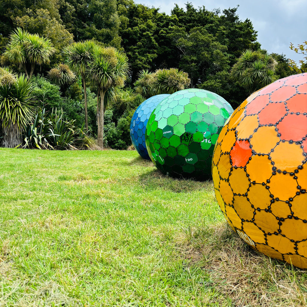 Patchwork of Possibilities: 3 spheres made from repurposed 44-gallon drums 